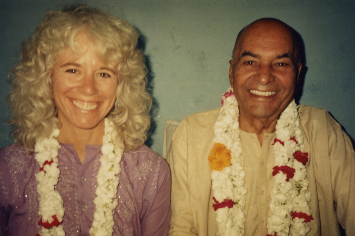 Gangaji and Papaji smiling with flowers