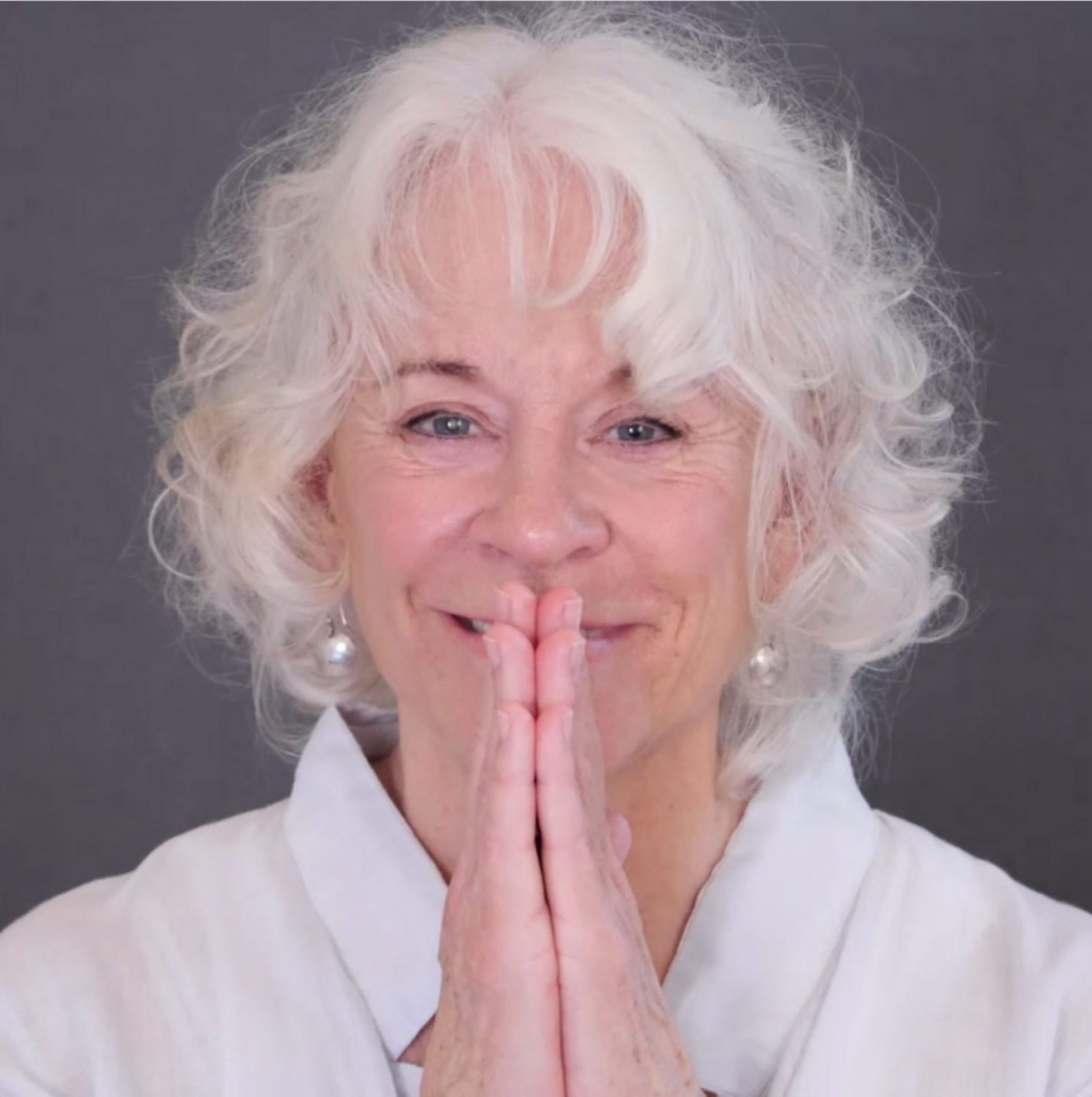 Gangaji-white-shirt-hands-in-namaste